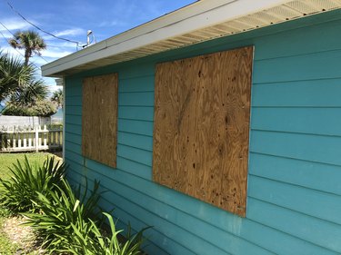 Plywood covers the windows of a beach cottage in Florida in preparation for an oncoming hurricane