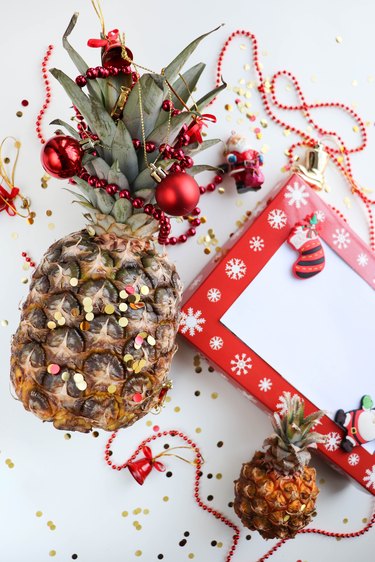 pineapple with christmas decorations and white blank for text