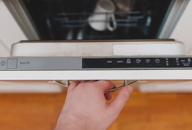 person closing dishwasher