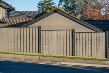 Slanted street with fence and house behind it in Australia