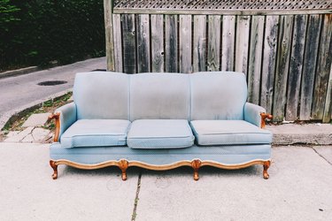 Couch Against Wooden Fence On Street