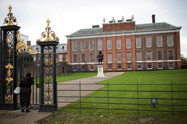 The entrance to Kensington Palace, featuring a black and gold iron gate
