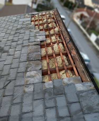 Slate tile roof under renovation after the passage of a tornado