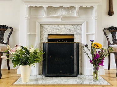Fireplace and fresh flowers.