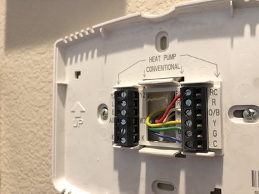 Installing a modern thermostat.