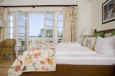 Bedroom with French doors opening onto balcony.