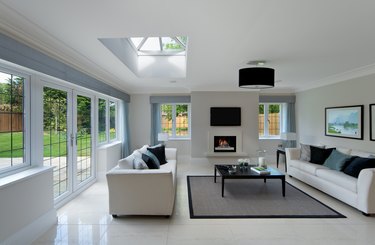Bright living room with skylight and tiled floor.