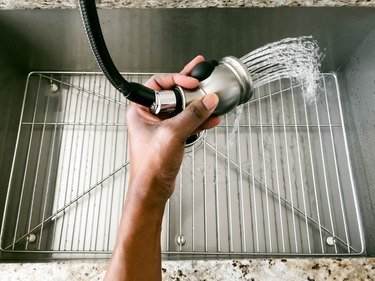 Woman Rinses Kitchen Sink