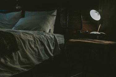 Man Lying Down On Bed At Home