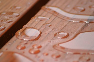 Raindrops on redwood deck.