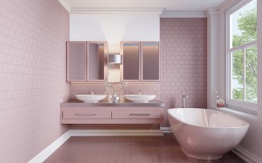 Modern-style home interior bathroom is tiled with pink tiles.