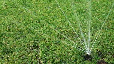 High Angle View Of Sprinkler On Grassy Field