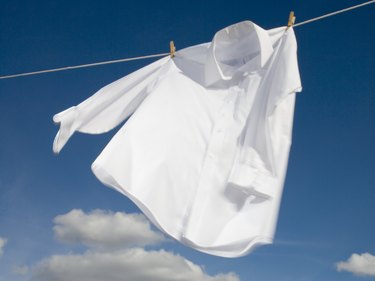 Closeup of white shirt air-drying on a clothesline.