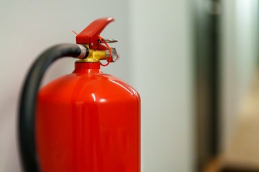 Red fire extinguisher hanging on the wall.