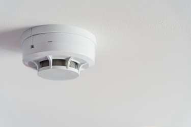 Close up smoke detector on a ceiling.