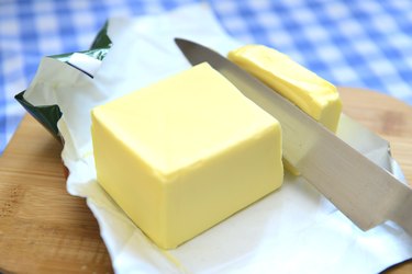 Butter being cut, knife through butter