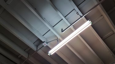 unfinished ceiling showing beam structure, electrical system, piping system and fluorescent lighting. industrial or loft style of interior decoration. bare ceiling for construction concept.