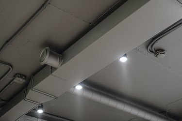 Ceiling ventilation ducts and LED lights. Engineering air system.