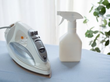 Iron and spray water on ironing board.