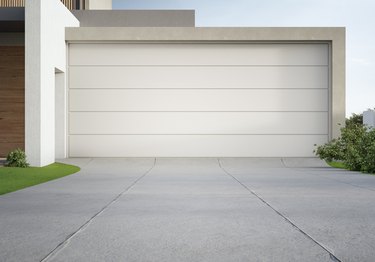 Modern house and garage with concrete driveway.