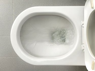 Flushing a toilet.