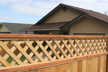 Wooden privacy fence with diagonal trellis detail