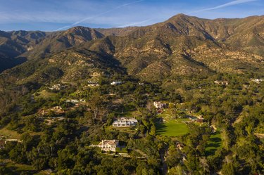 An aerial view of Montecito, California, showing the mountains and large homes