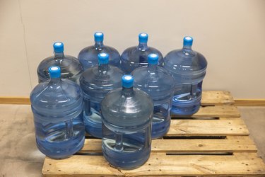 Closeup view of water bottles on pallet.
