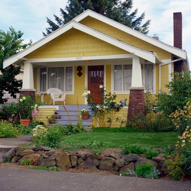 Yellow bungalow style house with garden, exterior view