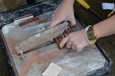 Cutting a tile using a tile cutter wheel