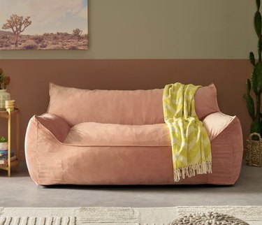 pink oversized velveteen beanbag sofa chair with armrests