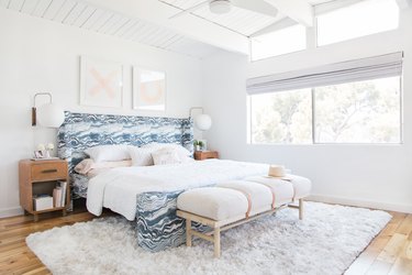 White bedroom with blue headboard