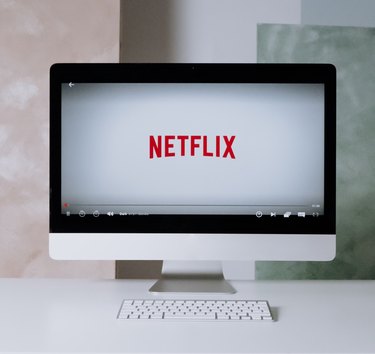 netflix logo on imac desktop on white desk