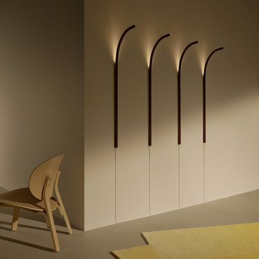 four long, curved wall lamps