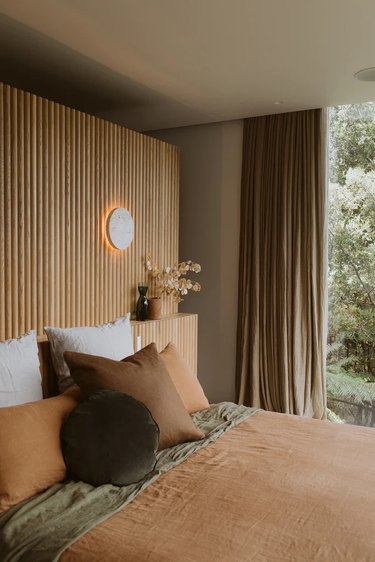 Brown bedroom with wooden accent wall