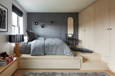 wood bedroom with gray padded walls