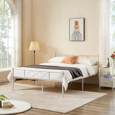 white metal bed frame in neutral bedroom