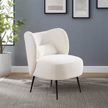 white fluffy chair with thin iron legs