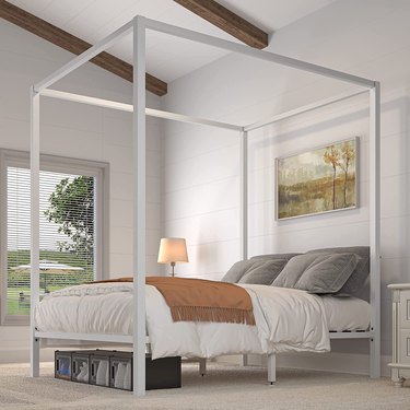 white metal canopy bed in bedroom