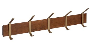 wall-mounted wood coat rack with gold hooks