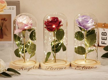 pink, red, and purple eternal roses in glass domes with personalized name