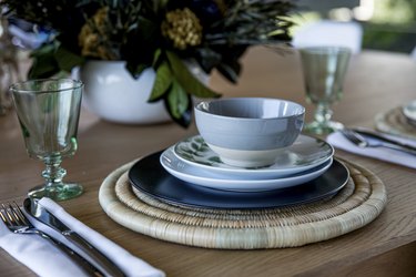 table with place settings and woven place mat