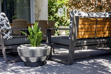 outdoor are with bench and woven basket with plant