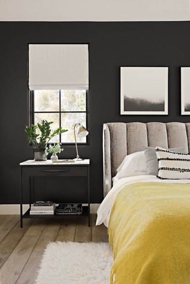 black bedroom with canary yellow blanket