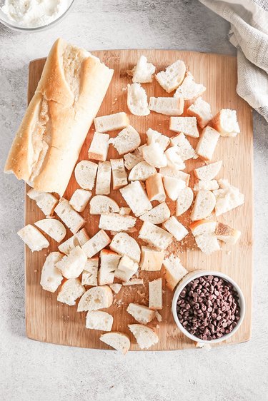 Cubes of bread on a wooden cutting board