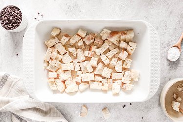 Half of bread in a large casserole dish