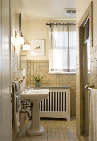 pint-size bathroom with marble-ledge heater cover