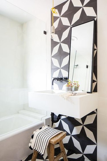 small modern bathroom with accent wall with pattern