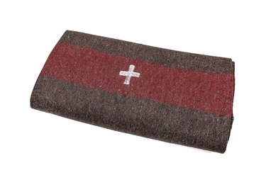 red and gray/brown blanket with white cross