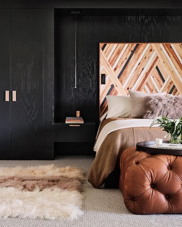 black wood walls with one-of-a-kind headboard